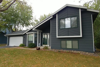 This is an example of a gey traditional two floor house exterior in Minneapolis with concrete fibreboard cladding.