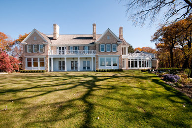 Example of a huge classic beige two-story brick exterior home design in Minneapolis