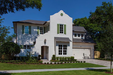 Large transitional white two-story stucco exterior home photo in Orlando