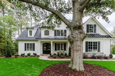 Inspiration for a mid-sized transitional white two-story wood house exterior remodel in Raleigh with a shingle roof