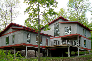 Example of a 1950s gray two-story concrete fiberboard exterior home design in New York