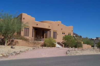 Design ideas for a medium sized and beige mediterranean two floor clay house exterior in Phoenix.