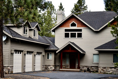 Example of a large arts and crafts beige two-story exterior home design in Other with a shingle roof