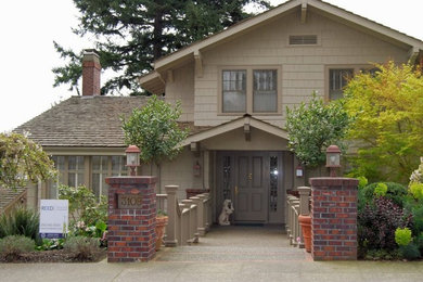 Example of a large brown two-story wood exterior home design in Seattle