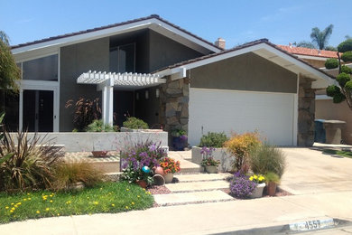 Inspiration for a mid-sized timeless brown one-story stucco exterior home remodel in Orange County with a shingle roof