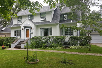 Example of a mid-sized classic white two-story house exterior design in Other