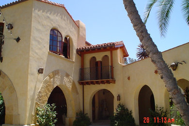 Huge tuscan beige three-story stucco gable roof photo in San Diego