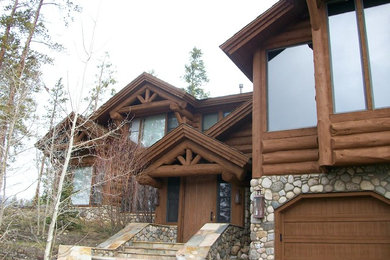 Diseño de fachada marrón grande de dos plantas con revestimiento de madera