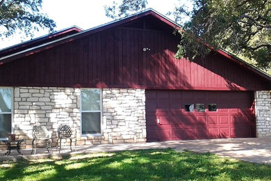 Inspiration for a large timeless red one-story wood exterior home remodel in Austin