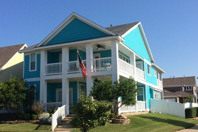 Inspiration for a large and blue coastal two floor house exterior in Dallas with wood cladding.