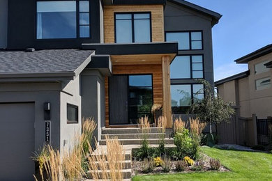 Example of a mid-sized minimalist gray two-story mixed siding house exterior design in Edmonton