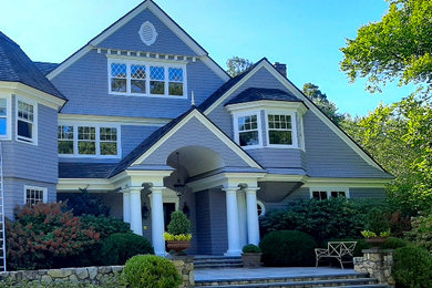 Large traditional gray three-story wood house exterior idea in New York with a shingle roof