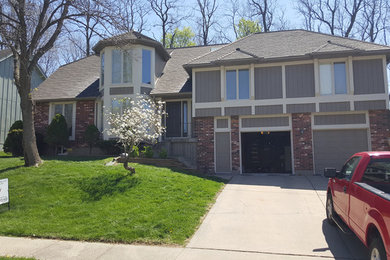 Example of a mid-sized classic gray two-story wood exterior home design in Kansas City with a hip roof