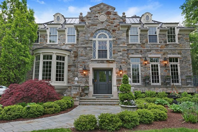 Mid-sized elegant beige two-story stone exterior home photo in Boston with a hip roof