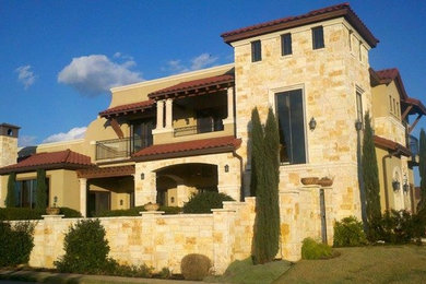 Example of a mid-sized tuscan beige three-story mixed siding exterior home design in Houston with a tile roof