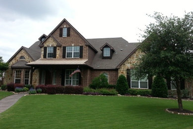 Example of a large country exterior home design in Dallas