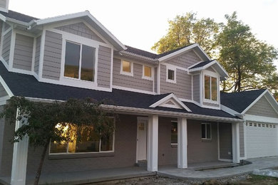 Example of a large transitional beige two-story wood exterior home design in Salt Lake City with a shingle roof