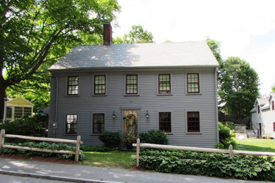Inspiration for a timeless gray wood exterior home remodel in Boston with a hip roof