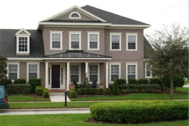 Example of a large brown one-story exterior home design in Tampa