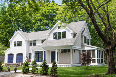 Inspiration for a mid-sized timeless beige two-story wood exterior home remodel in Boston with a shingle roof