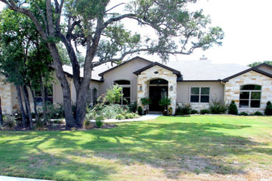 This is an example of a large and brown mediterranean bungalow house exterior in Austin with mixed cladding and a hip roof.