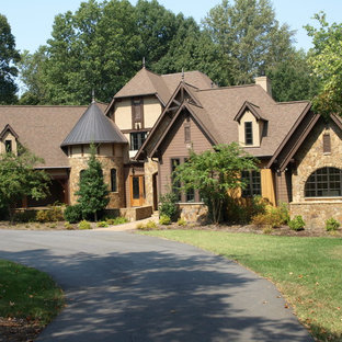 Huge craftsman brown three-story stone exterior home idea in Charlotte