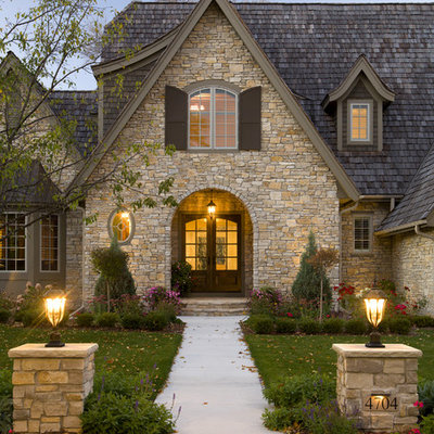 Traditional two-story stone exterior home idea in Minneapolis