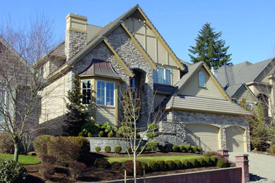 Inspiration for a large timeless beige two-story mixed siding house exterior remodel in Portland