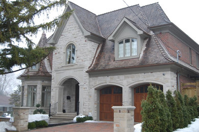 Inspiration for a large brown two-story wood exterior home remodel in Toronto