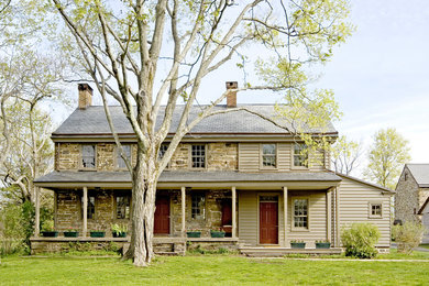 Farmhouse stone exterior home idea in Philadelphia