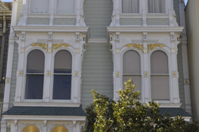 Large white three-story vinyl exterior home idea in San Francisco