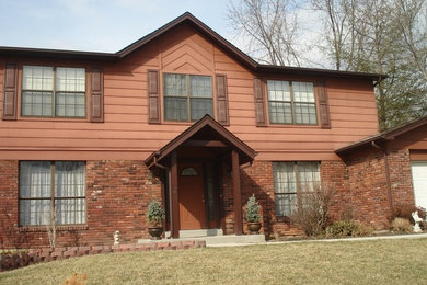 Example of a large classic brown two-story wood exterior home design in St Louis