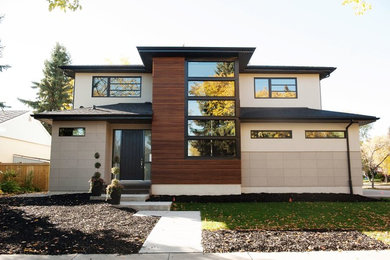 Example of a huge trendy beige two-story mixed siding exterior home design in Edmonton with a hip roof