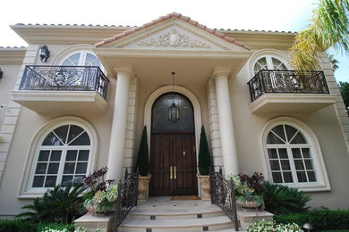 Mid-sized traditional beige two-story stucco gable roof idea in Los Angeles