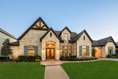 Large traditional white one-story stone exterior home idea in Houston