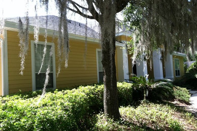 Example of a mid-sized yellow one-story wood exterior home design in Miami