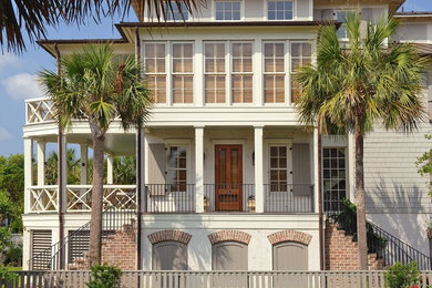 Huge beach style beige three-story mixed siding exterior home photo in Charleston