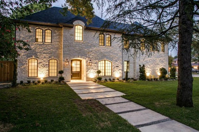 Mid-sized transitional beige two-story stone exterior home idea in Dallas with a hip roof