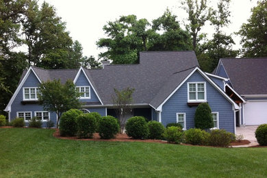 Inspiration for a large and blue classic two floor house exterior in Charlotte with wood cladding and a pitched roof.