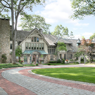 Inspiration for a traditional two-storey beige exterior in New York with mixed siding.