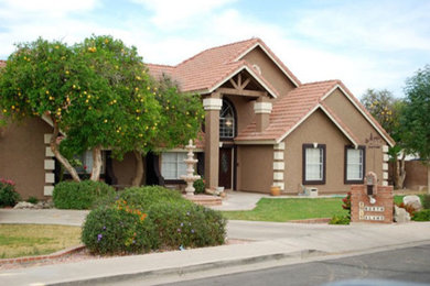 Example of a large beige two-story exterior home design in Phoenix