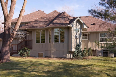 Medium sized and beige traditional bungalow detached house in Minneapolis with concrete fibreboard cladding, a pitched roof and a shingle roof.