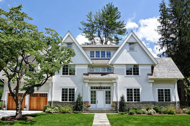 Example of a mid-sized classic white three-story wood exterior home design in New York