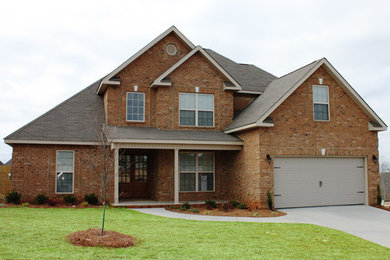 Example of a red two-story brick exterior home design in Atlanta