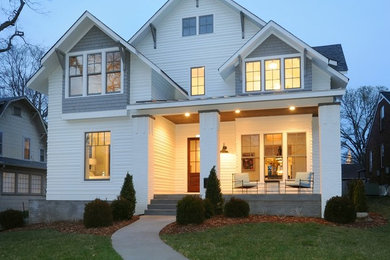 Mid-sized transitional white two-story vinyl exterior home idea in Nashville with a shingle roof
