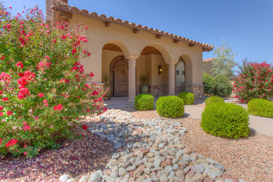 Inspiration for a southwestern beige one-story stone flat roof remodel in Albuquerque
