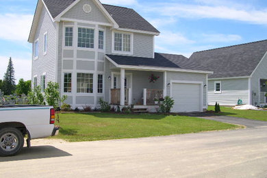 Example of a mid-sized gray two-story wood exterior home design in Burlington