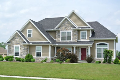 Example of a mid-sized beige two-story mixed siding exterior home design in Other