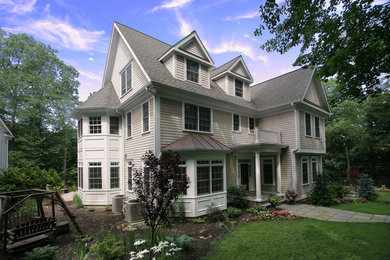 Large gray three-story wood gable roof photo in New York