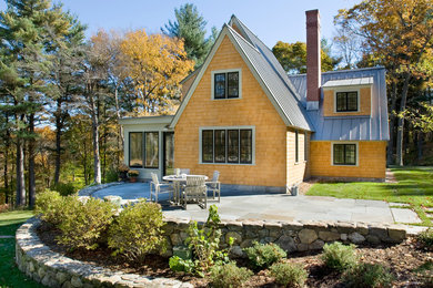 Inspiration for a small cottage beige two-story wood gable roof remodel in Boston
